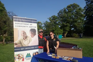 photo of DCJ booth and staff at National Night Out 2014