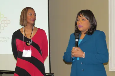 Commissioner Loretta Smith (right) accepts her award at the Black Women for Peace event as Regena Warren looks on.