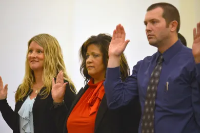Parole and probation officers Kelly Johnson, Kelly Irish and Benjamin Geiger take oath of office.  