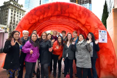 Health Department employees pose under the Strollin Colon, a large inflated cross section of a model colon
