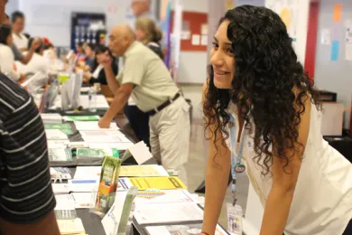 Community outreach intern Jessie Osuna-Mondragon helps residents figure out if they're eligible for food benefits at a recent community fair.