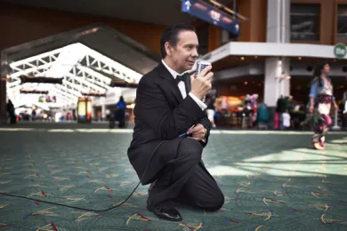 Sinatra tribute artist and formerly homeless veteran Frank English serenades travelers as they pass through PDX airport