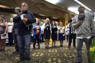 Veterans stand for the Pledge of Allegiance at the annual Stand Down at Veterans Memorial Coliseum on Friday.    