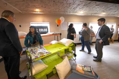 Attendees including Commissioner Jules Bailey (far right) check out the beds for the new shelter.  