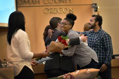 Commissioner Jules Bailey hugs Nina Phillips, member of the ACHIEVE Coalition