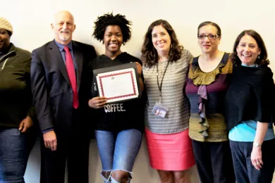 Kalisha poses with family and DCJ staff 