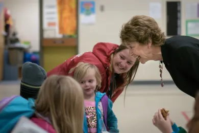 Commissioner Diane McKeel chats with a student before class at Lynch Meadows Elementary