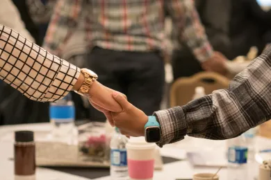 Photo of mother and son holding hands at the Black Men and Boys Healing Summit last Summer