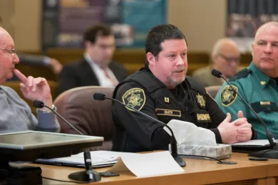 Sheriff's Capt. Harry Smith briefs board flanked by Mayor Ted Tosterud and Sheriff's Chief Jason Gates