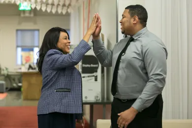 Commissioner Loretta Smith gives a high five to SummerWorks intern Zuriel Hammond, who landed a paid year-long internship with Multnomah County.