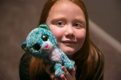 Surri Noelle and one of the stuffed animals she's collected for her new home through the Home for the Holidays campaign.
