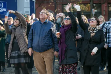 County Commissioners cheer the hoisting of the last steel beam at the Health Department headquarters.