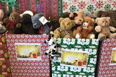 Stuffed animals overflowing out of gift wrapped boxes