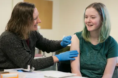 Karlyn Kelley, a 6th grader at Rockwood Preparatory Academy, smiles after getting her shots.
