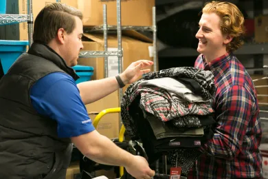 Volunteers with the construction firm JE Dunn sort clothing donations at Bud Clark Commons.