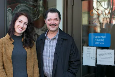 53-year-old Ty Grove poses with Central City Concern case manager Juliana DePietro