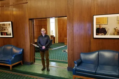 Multnomah County photographer Motoya Nakamura stands among prints in his Images of the 442nd: Nisei Japanese American WWII Veterans and Their Continuing Legacy exhibition currently on display in the Governor's Office