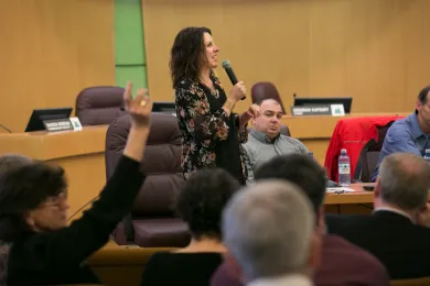 Chair Kafoury Takes Questions during a forum on energy efficiency, Kafoury seen standing as the audience raises their hands to ask questions. 