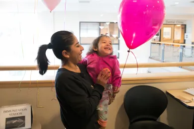 Aliyael Diaz-Moreno giggles iwth her mom Liliana Moreno after getting her flu shot at the Baby Day Dental clinic in Gresham.