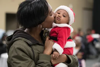 Shaqualia Roach kisses her son, 3-month-old Hasani. But people call him Nugget.