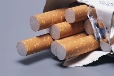 Pack of cigarettes on its side with 5 sticking out