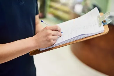 Image of person with clipboard and pen - Charday Penn/Getty Images