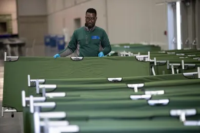 County employees work to set up temporary shelter space at the Oregon Convention Center on Friday, March 20, 2020.
