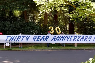 IDEA (Including Disability in Equity and Access) Employee Resource Group members hold sign up celebrating 30 years of ADA