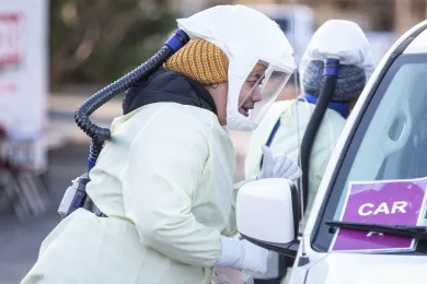 Nurses administer test at a COVID-19 testing site.
