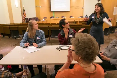 Commissioner Meieran speaking to group of community members at event.