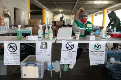 Indvidual prepares to greet guests to a severe weather shelter site.