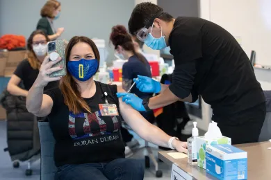 A county employee takes a selfie during a vaccine clinic.