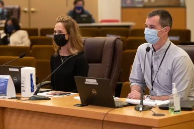 An image of Christian Elkin, Budget Director, and Jeff Renfro, Economist at a Board meeting