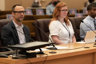 (left to right): Brian Hughes, Christa Jones, and Ron Kates testify before the Board of Commissioners