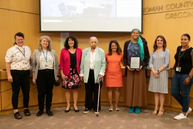 Board of Commissioners present the Kathleen Saadat Award to local educator and advocate Erin Waters and proclaim June as Pride Month