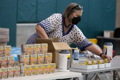 Beth Appert, a Public Health employee, lays out snacks at a cooling shelter, July 26, 2022