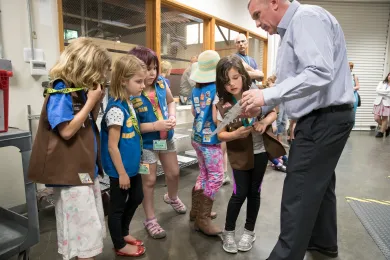 Multnomah County Elections Director Tim Scott (right) shows elections material to a Girl Scouts troop during a May 2018 tour. 