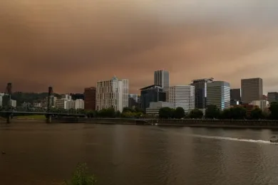Smoke fills the skies above the Willamette River with downtown Portland in the background