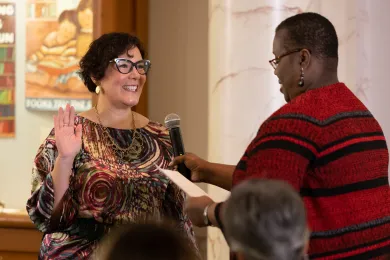 Chair Jessica Vega Pederson raises her right hand as she stand in front of and is sworn in by Oregon Supreme Court Justice Adrienne Nelson