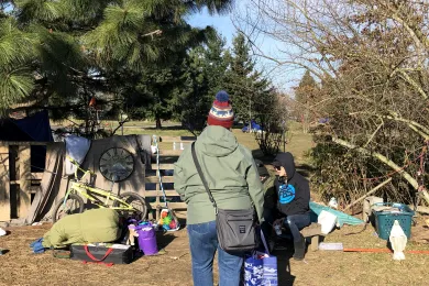 Outreach worker talking to a person on the street in Portland