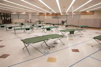 Photo of cots set up in a large room