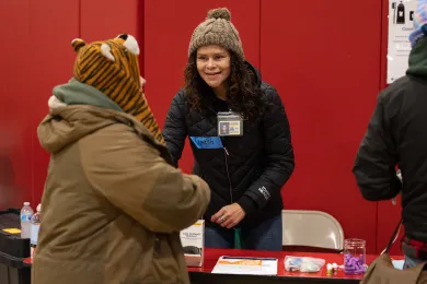 Staff member helps a person staying at the Salvation Army warming shelter