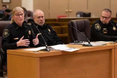 Sheriff Nicole Morrisey O’Donnell, Chief Deputy James Eriksen and Captain Doug Asboe behind a table presenting to the Board of County Commissioners.