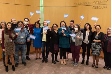 Board of Commissioners and community members pose during board meeting on March 23, 2023