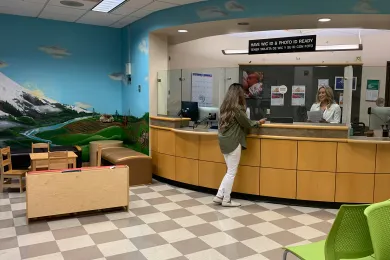 A WIC client checking in at the East County WIC clinic.