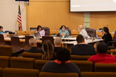 The Board of County Commissioners sits at a round table in the Boardroom