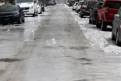 Icy road with parked cars