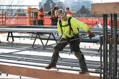 Construction worker installs steel rebar on third floor of the new Central Courthouse