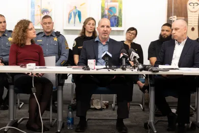 (Left to right): Dr. Jennifer Vines, Sean McGann and Mike Myers of Unified Command brief the media on the first 30 days of the emergency