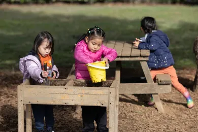 Children play outside at a PFA site